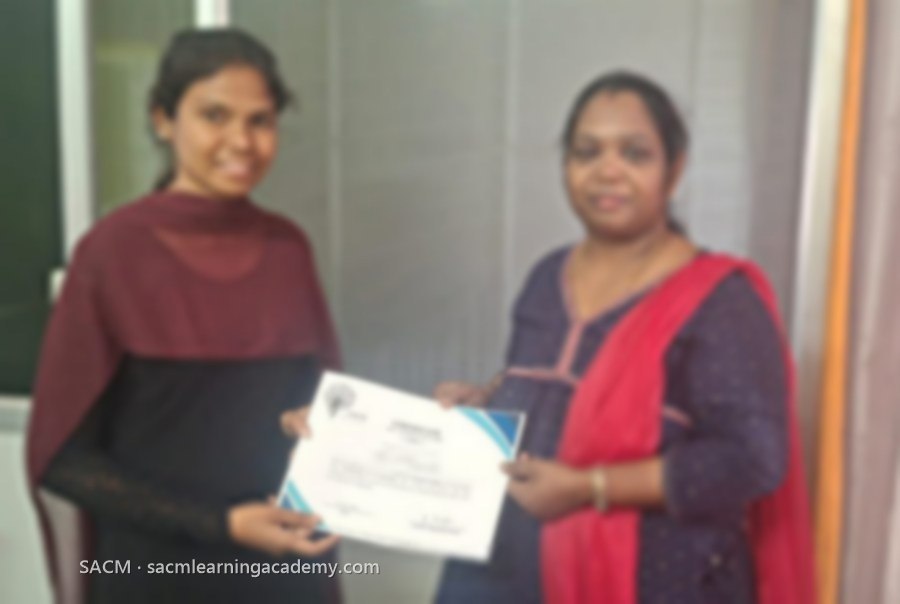 SACM trainer presenting an Advanced Medical Coding certificate of completion to a student