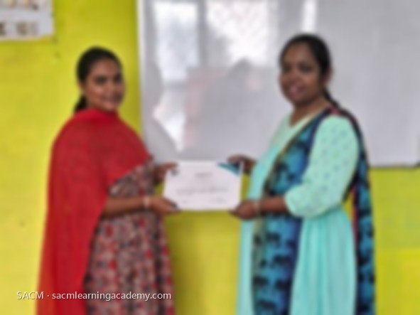 SACM student receiving a certificate of completion from her trainer