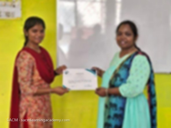 SACM student receiving a certificate of completion from her trainer