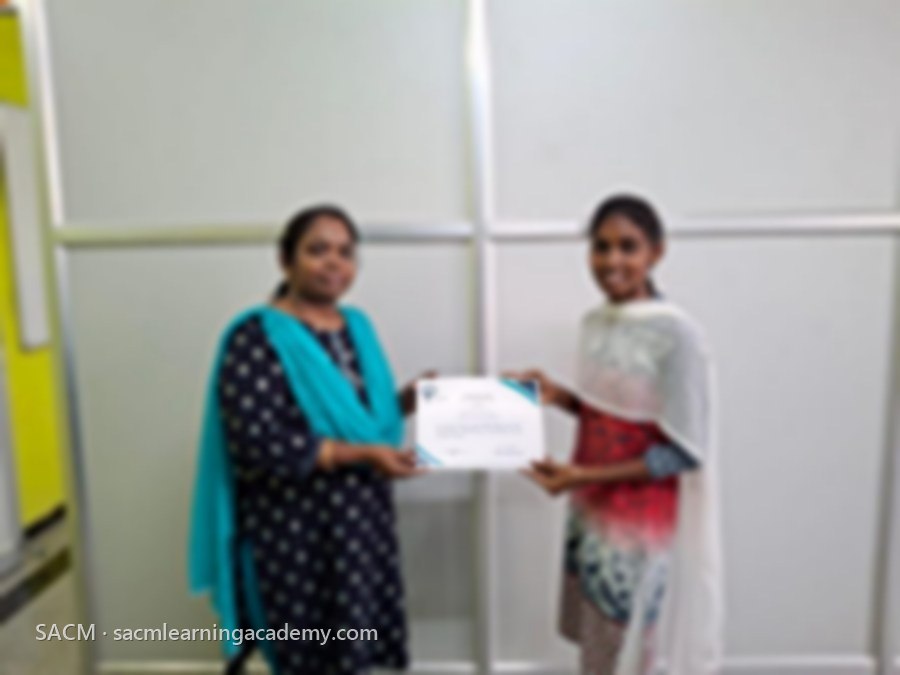 SACM student receiving a certificate of completion from her trainer