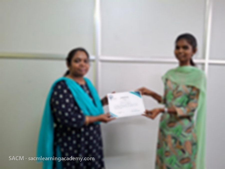 SACM student receiving a certificate of completion from her trainer