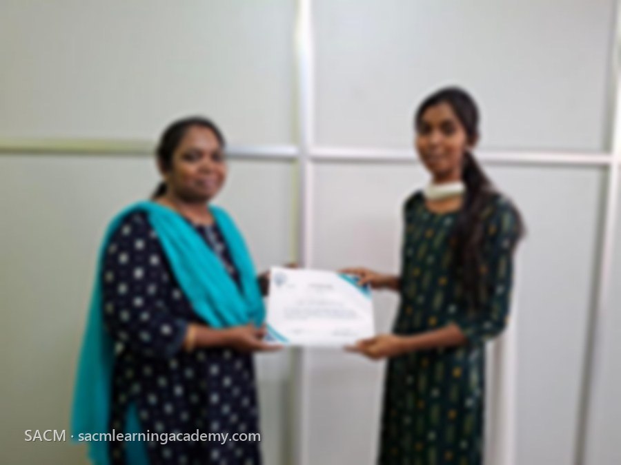 SACM student receiving a certificate of completion from her trainer