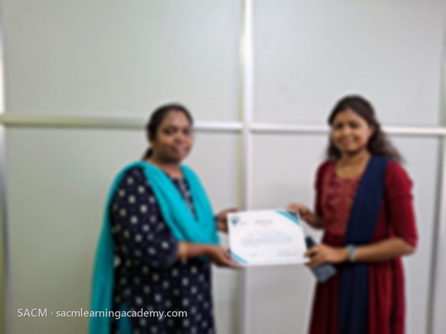 SACM student receiving a certificate of completion from her trainer