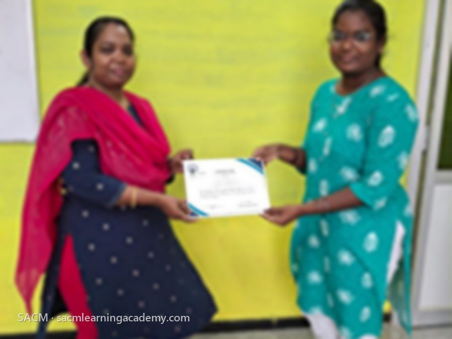 SACM student receiving a certificate of completion from her trainer