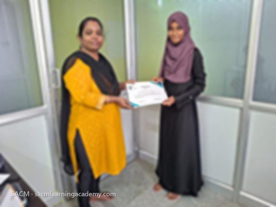 SACM student receiving a certificate of completion from her trainer