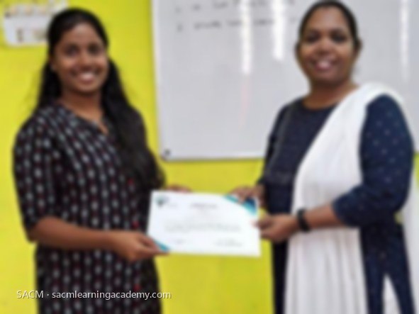 SACM student receiving a certificate of completion from her trainer