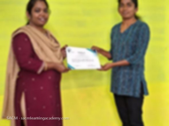 SACM student receiving a certificate of completion from her trainer